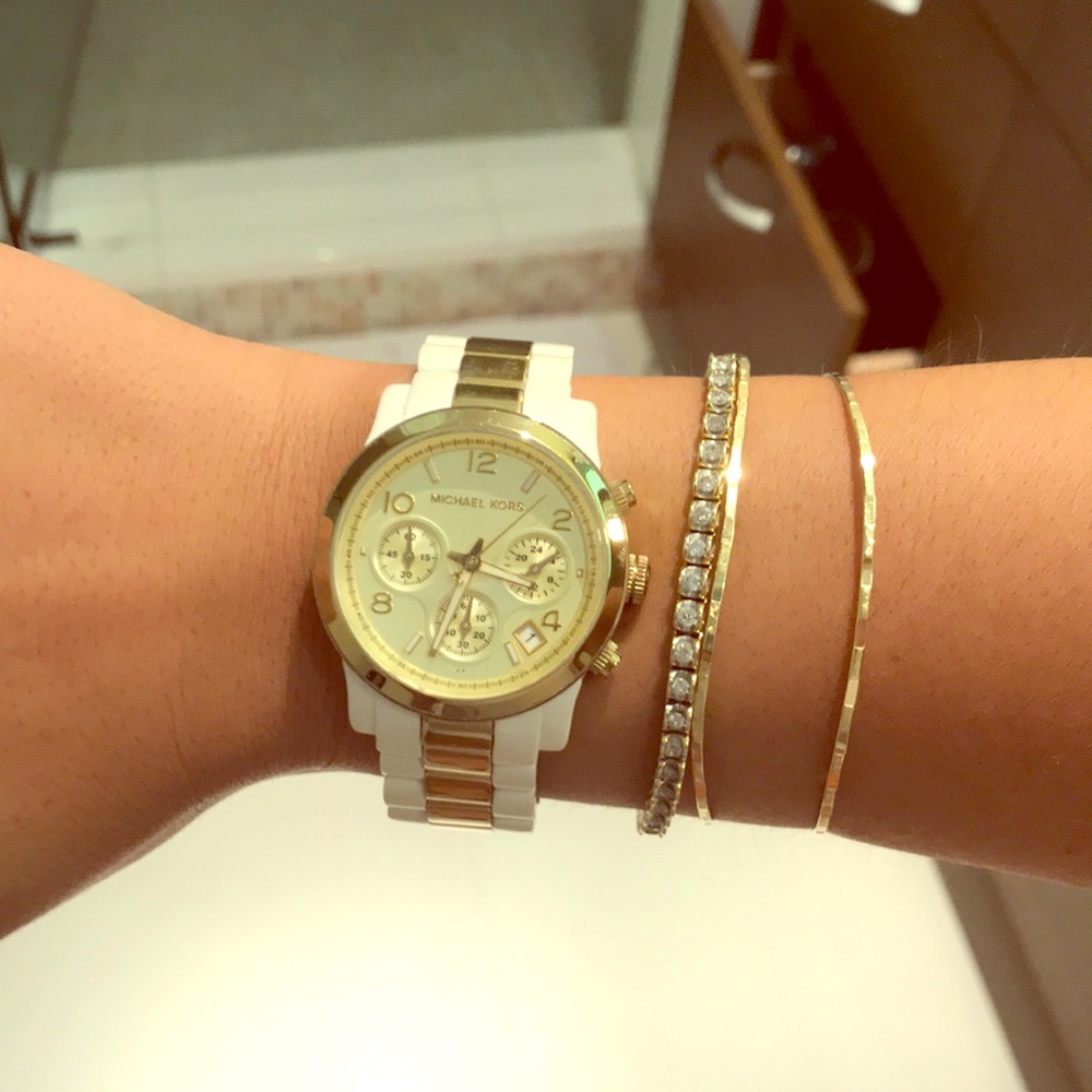 White and gold Michael Kors watch.